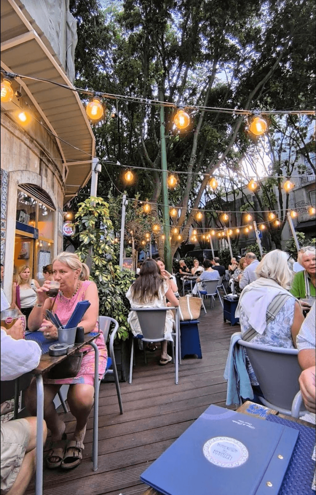 Guests dining on the outdoor terrace in the evening