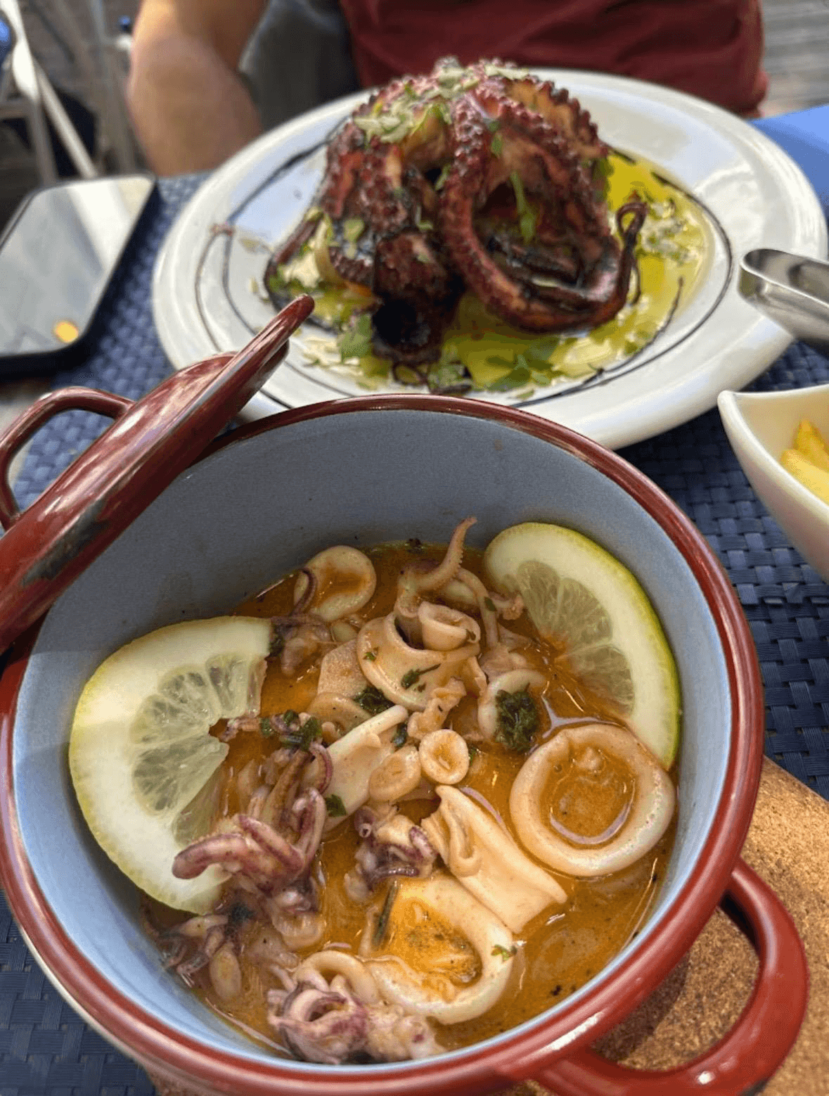 Seafood cataplana beside octopus salad